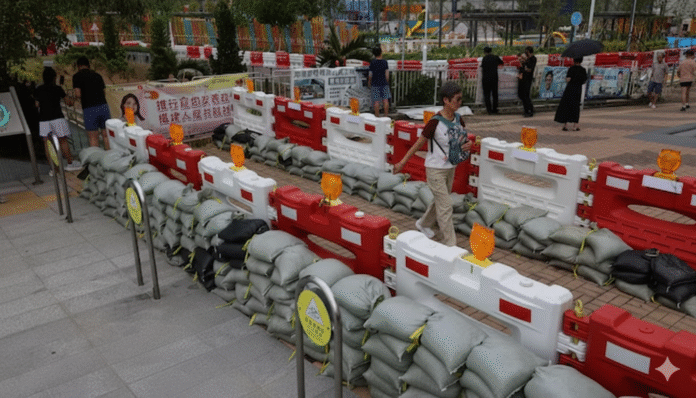 Gemini_Generated_Image_nf48ztnf48ztnf48 Residents walk past sandbags placed to prevent flooding from Super Typhoon Ragasa in Hong Kong