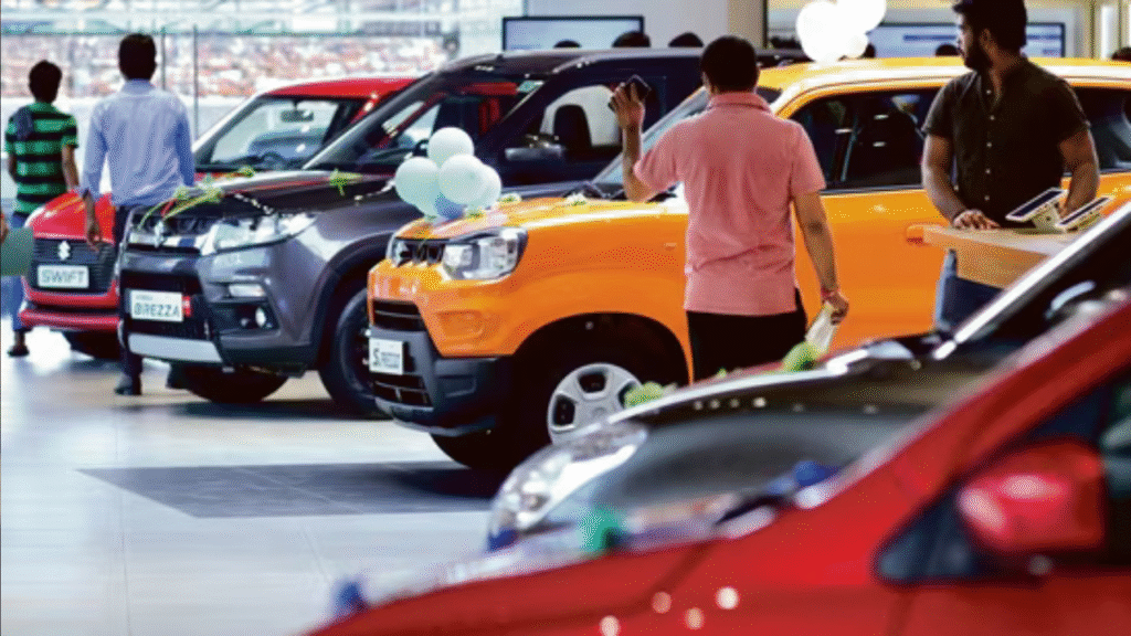 Customers exploring Maruti Suzuki cars at a showroom after price cuts following GST reforms in India.