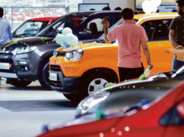 Customers exploring Maruti Suzuki cars at a showroom after price cuts following GST reforms in India.