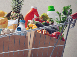 A shopping cart filled with groceries.